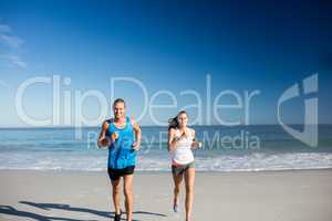 Friends jogging at the beach