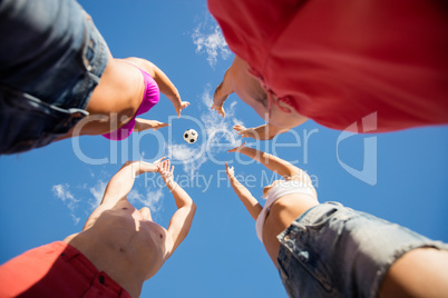 Low angle view of friends playing with a ball