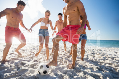 Friends playing football