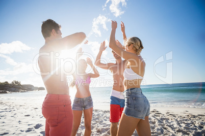 Friends dancing at the beach