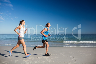 Friends jogging at the beach