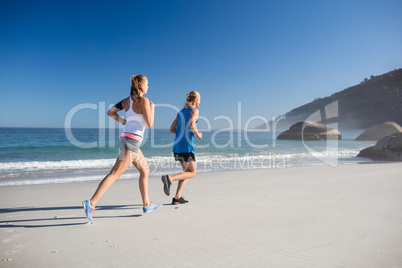 Friends jogging at the beach