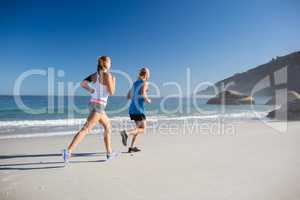 Friends jogging at the beach