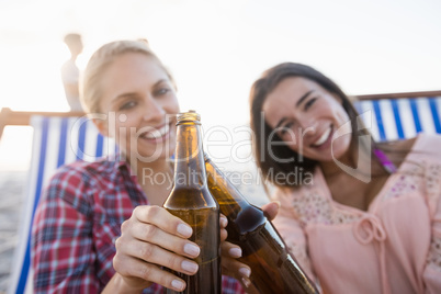 Smiling friends cheering with beer