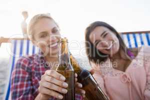 Smiling friends cheering with beer