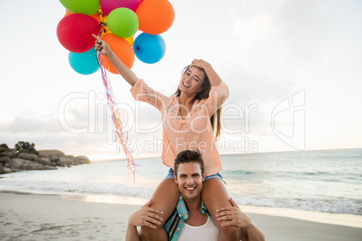 Man giving piggyback to woman