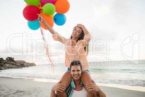 Man giving piggyback to woman