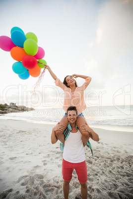 Man giving piggyback to woman