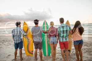 Friends holding a surfboard