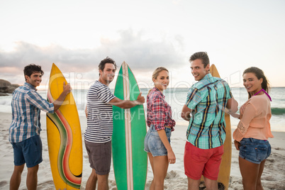 Friends holding a surfboard