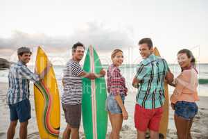 Friends holding a surfboard