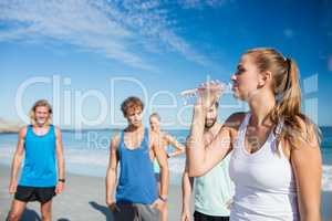 Fit woman drinking water