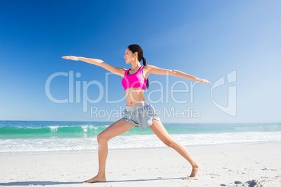 Woman doing yoga on the beach