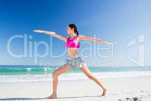 Woman doing yoga on the beach