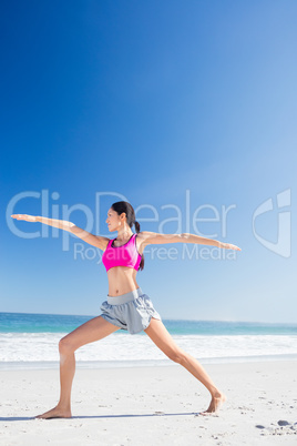 Woman doing yoga on the beach