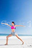 Woman doing yoga on the beach