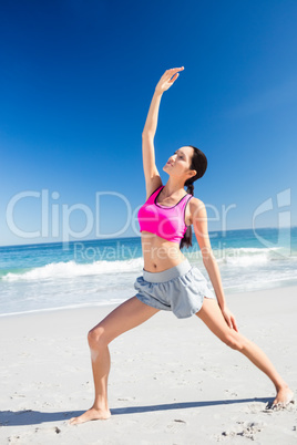 Woman doing yoga on the beach