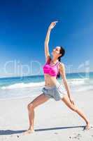 Woman doing yoga on the beach