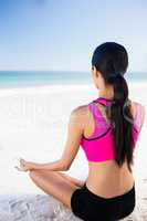 Woman doing yoga on the beach