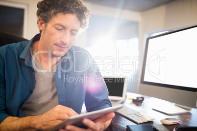 A businessman looking his tablet
