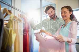 Woman showing shirt to man at shopping mall