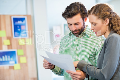 Businessman and businesswoman looking at diary