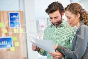 Businessman and businesswoman looking at diary