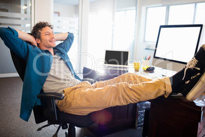 A businessman is relaxing on his chair