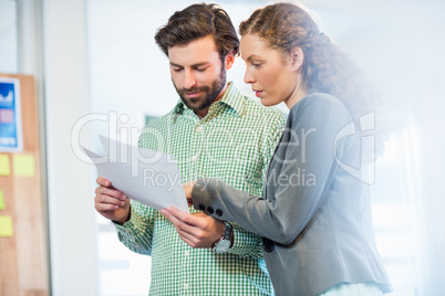 Businessman and businesswoman looking at diary