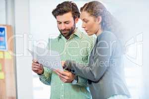 Businessman and businesswoman looking at diary