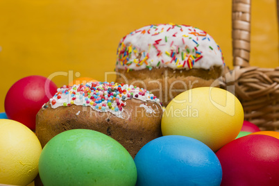 Easter eggs of different colors and cake