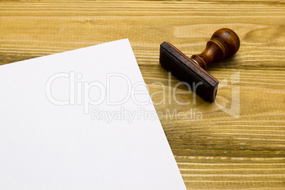 Wooden stamp and a sheet of paper