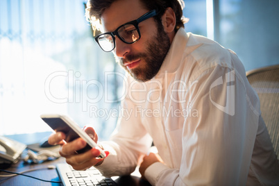 Businessman working and looking his phone