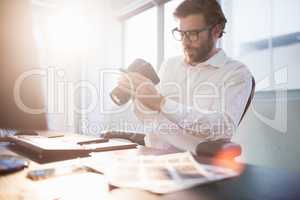 Businessman looking photos on his camera