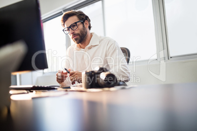 Photographer with glasses working on his computer
