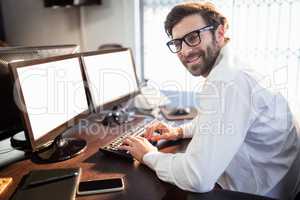 Businessman with glasses smiling and working