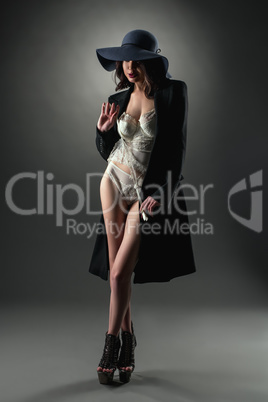 Model dressed in sexy lace lingerie, coat and hat