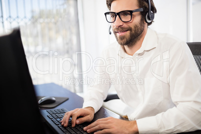 Businessman with glasses smiling and working