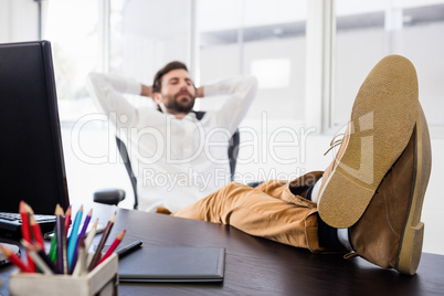 Relaxing man with his leg crossed on the desk