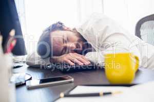 A man sleeping on his desk