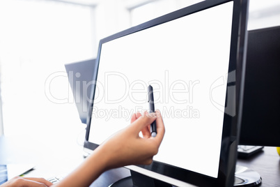 Casual businesswoman touching her computer