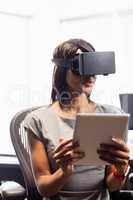 Businesswoman looking her tablet while using a virtual glasses