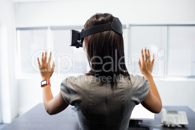 Businesswoman standing while using a virtual glasses