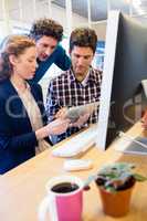 Businesspeople working and holding a tablet