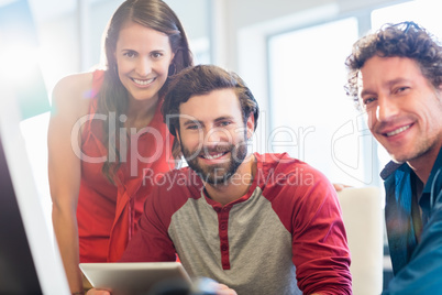 Smiling colleagues using a tablet