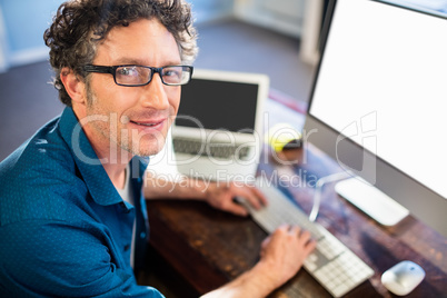 Smiling businessman working on computer