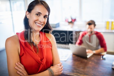 Smiling businesswoman with arms crossed