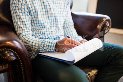 Man writing on clipboard