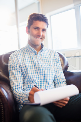 Man writing on clipboard