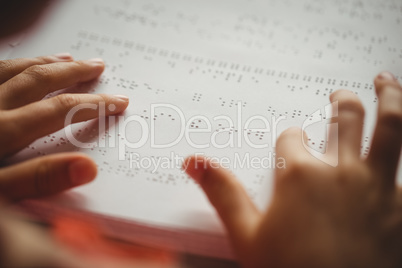Girl using braille to read
